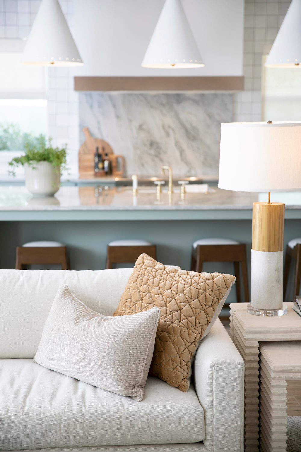 A coastal inspired living area with crisp whites, warm wood tones, and textural accents by Lisa & Leroy.