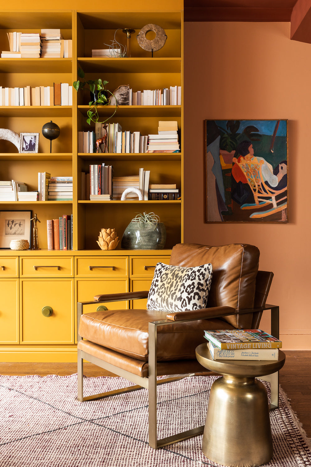A living area in sunset tones, featuring built-ins in mustard yellow by Lisa & Leroy.