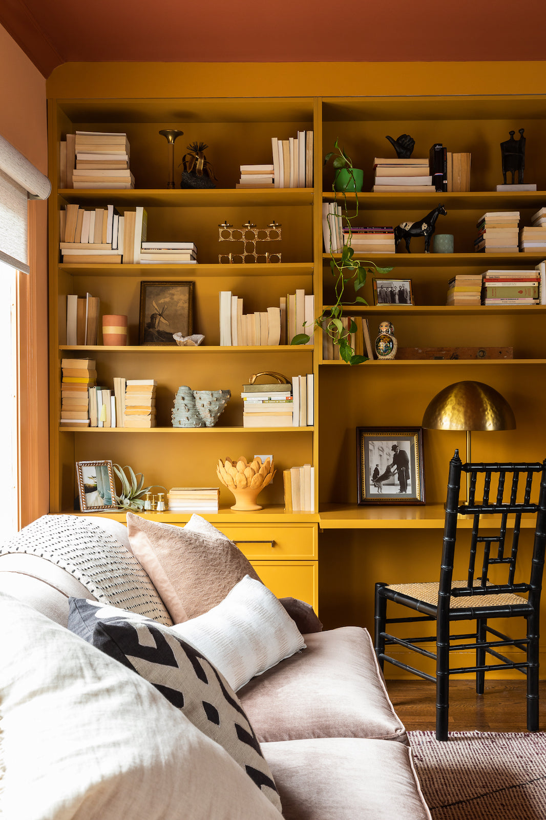 Built-ins in mustard yellow in a living area designed by Lisa & Leroy.