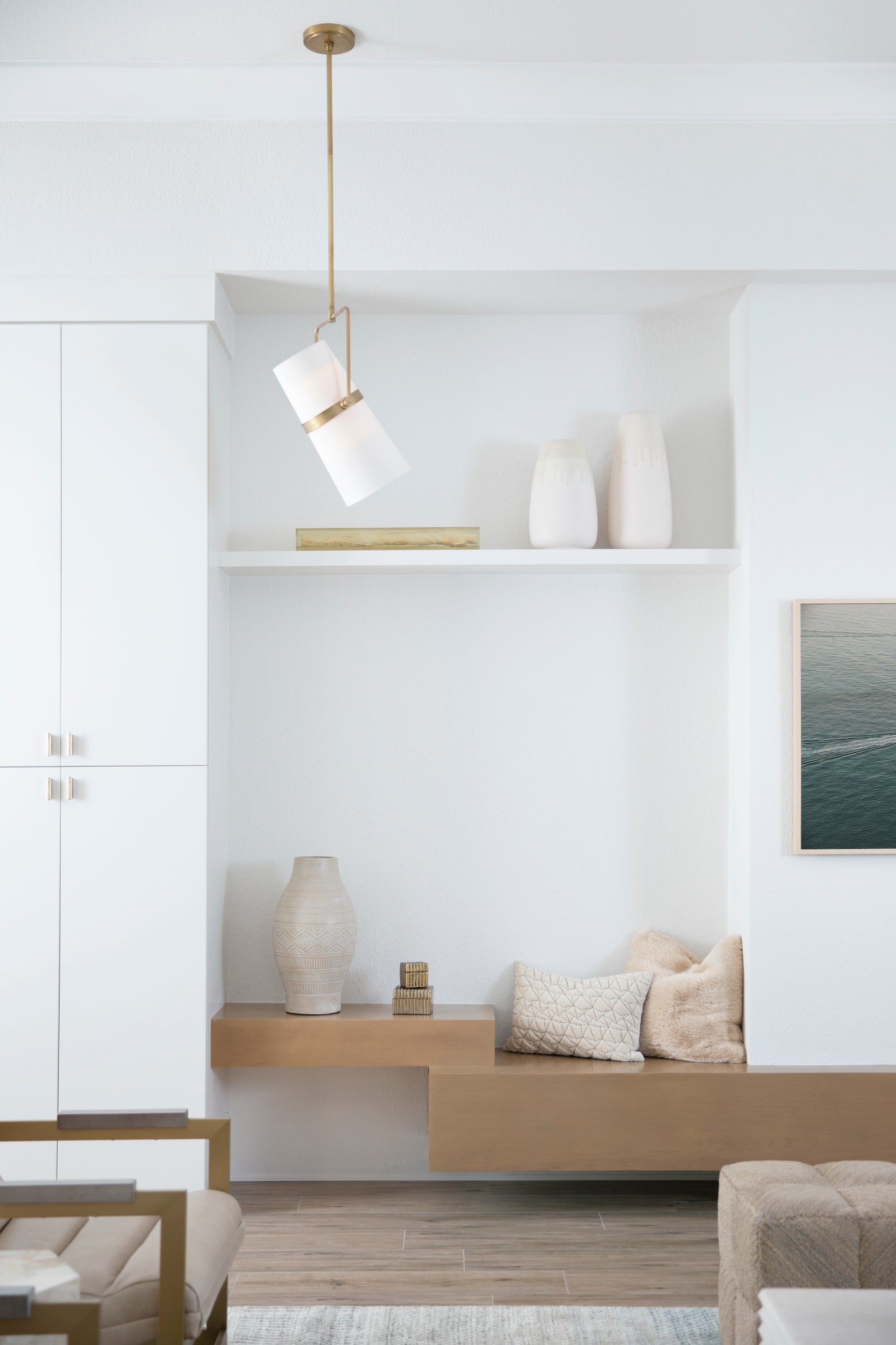 A coastal inspired living area with crisp whites, warm wood tones, and textural accents by Lisa & Leroy.