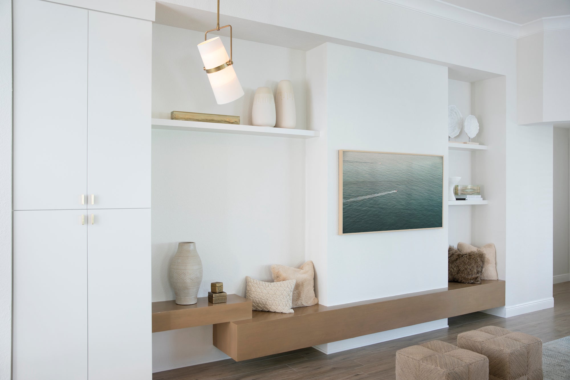 A coastal inspired living area with crisp whites, warm wood tones, and textural accents by Lisa & Leroy.