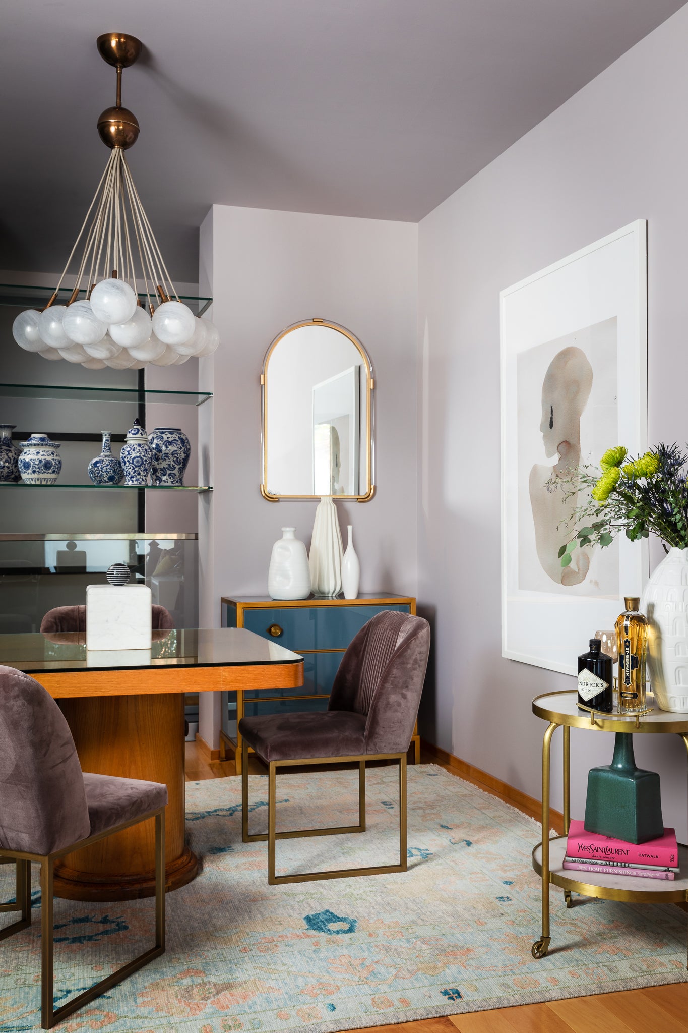 A dining area featuring soft violets and deep blues, by Lisa & Leroy.