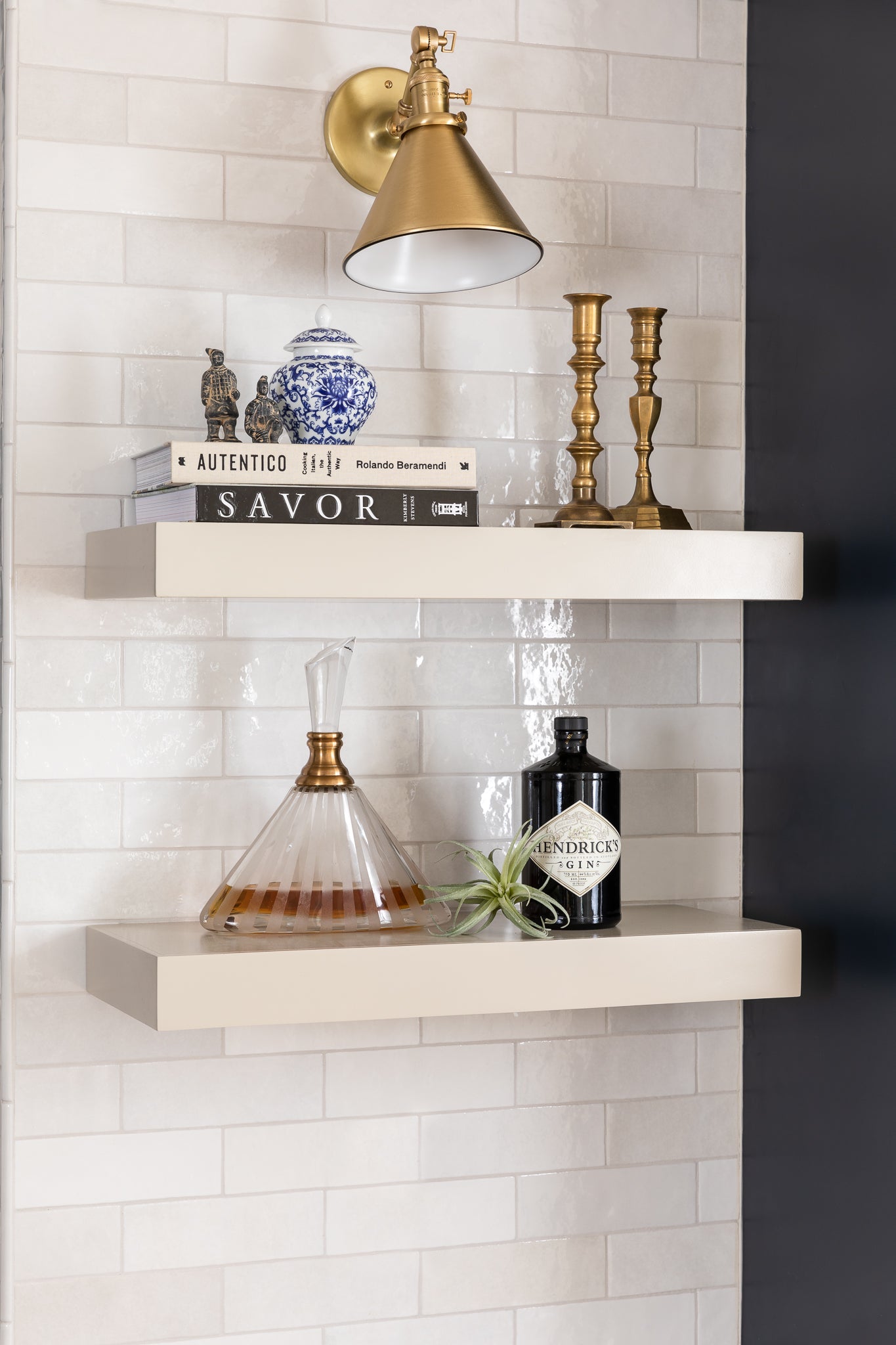 An elevated neutral kitchen with navy cabinets and ceramic tile, by Lisa & Leroy.