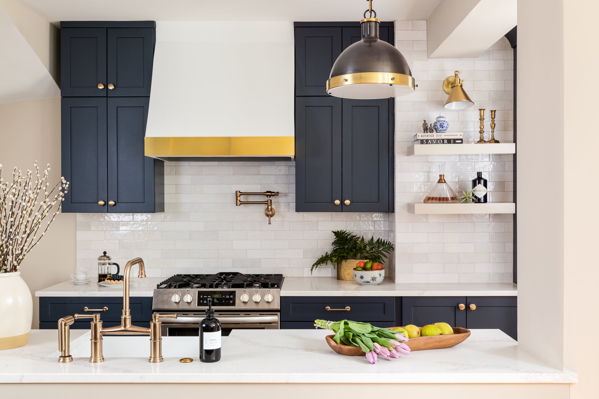 An elevated neutral kitchen with navy cabinets and ceramic tile, by Lisa & Leroy.