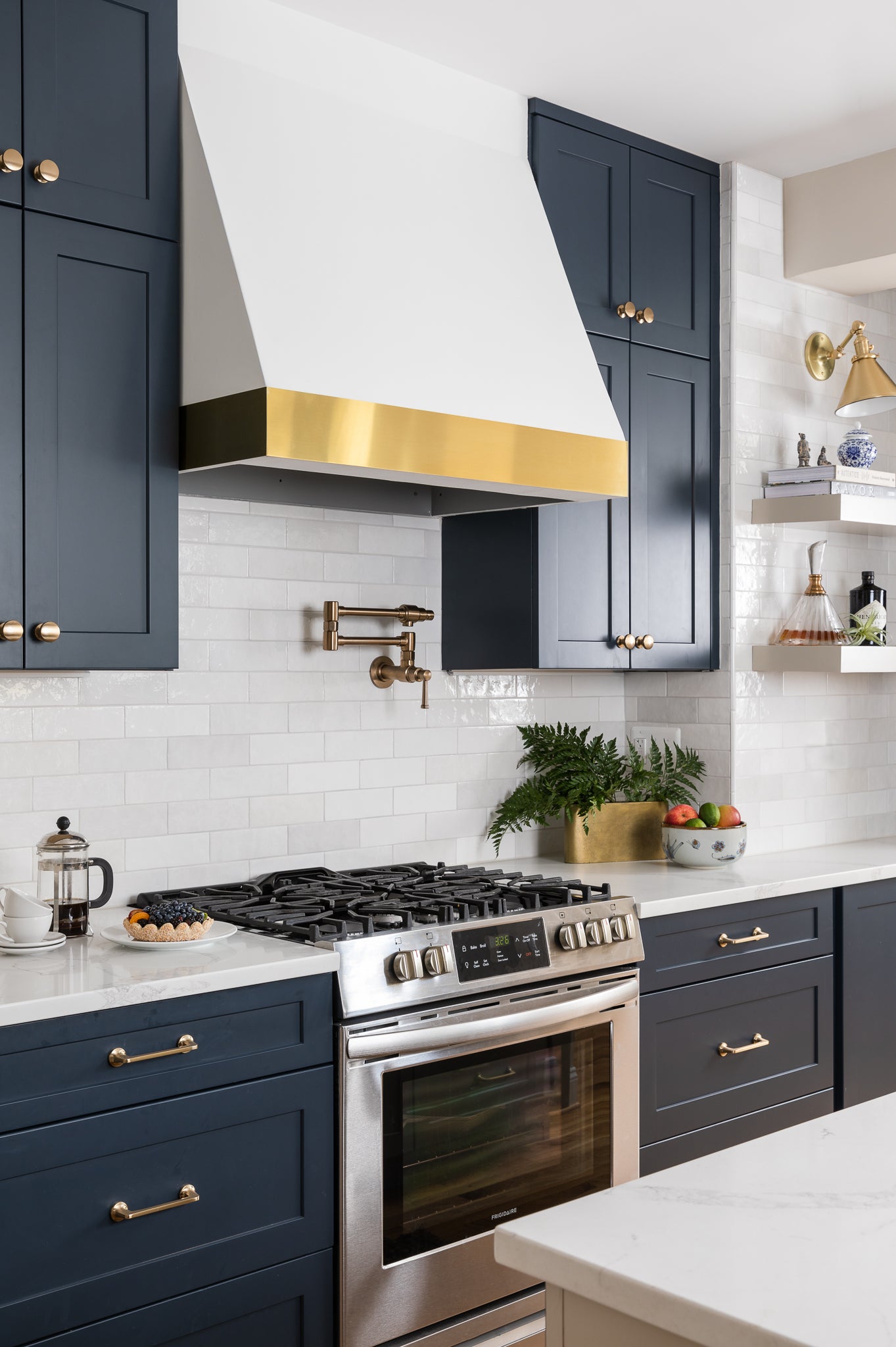An elevated neutral kitchen with navy cabinets and ceramic tile, by Lisa & Leroy.