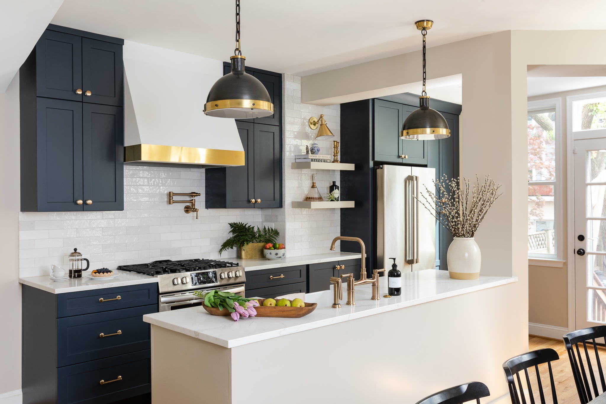 An elevated neutral kitchen with navy cabinets and ceramic tile, by Lisa & Leroy.
