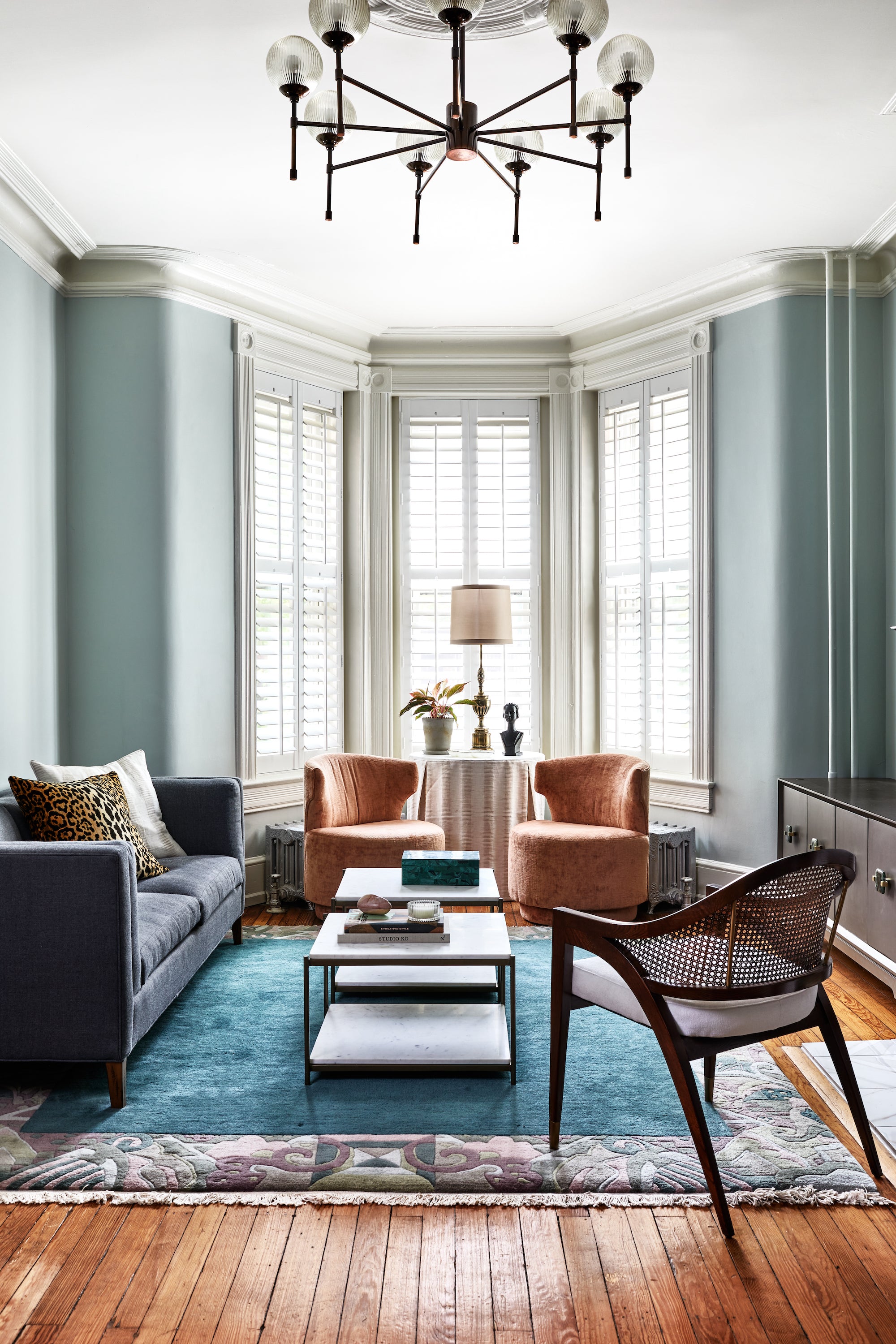 A timeless living area featuring an original fireplace and classic furnishings, by Lisa & Leroy.