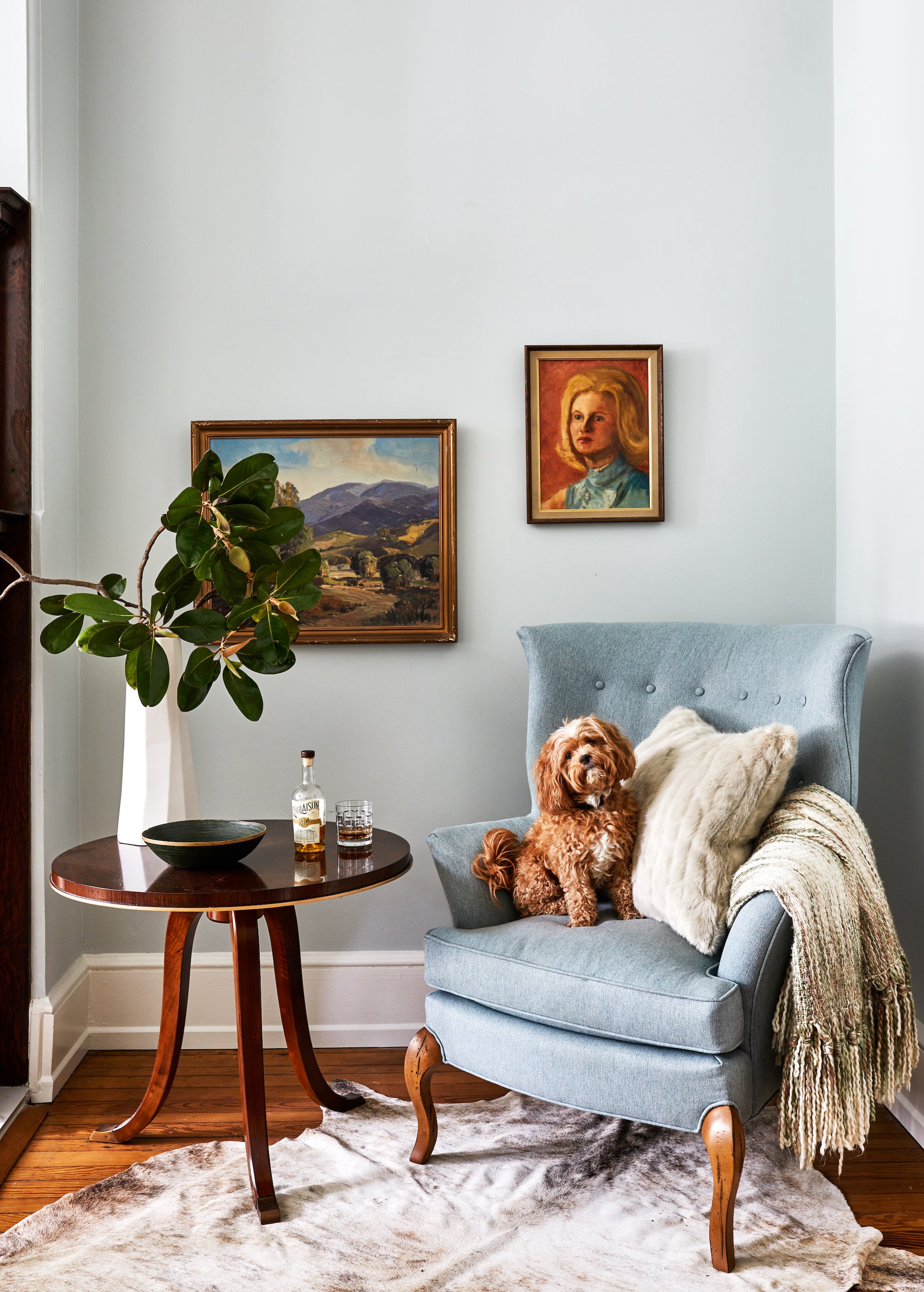 A timeless living area featuring antique art and classic furnishings, by Lisa & Leroy.
