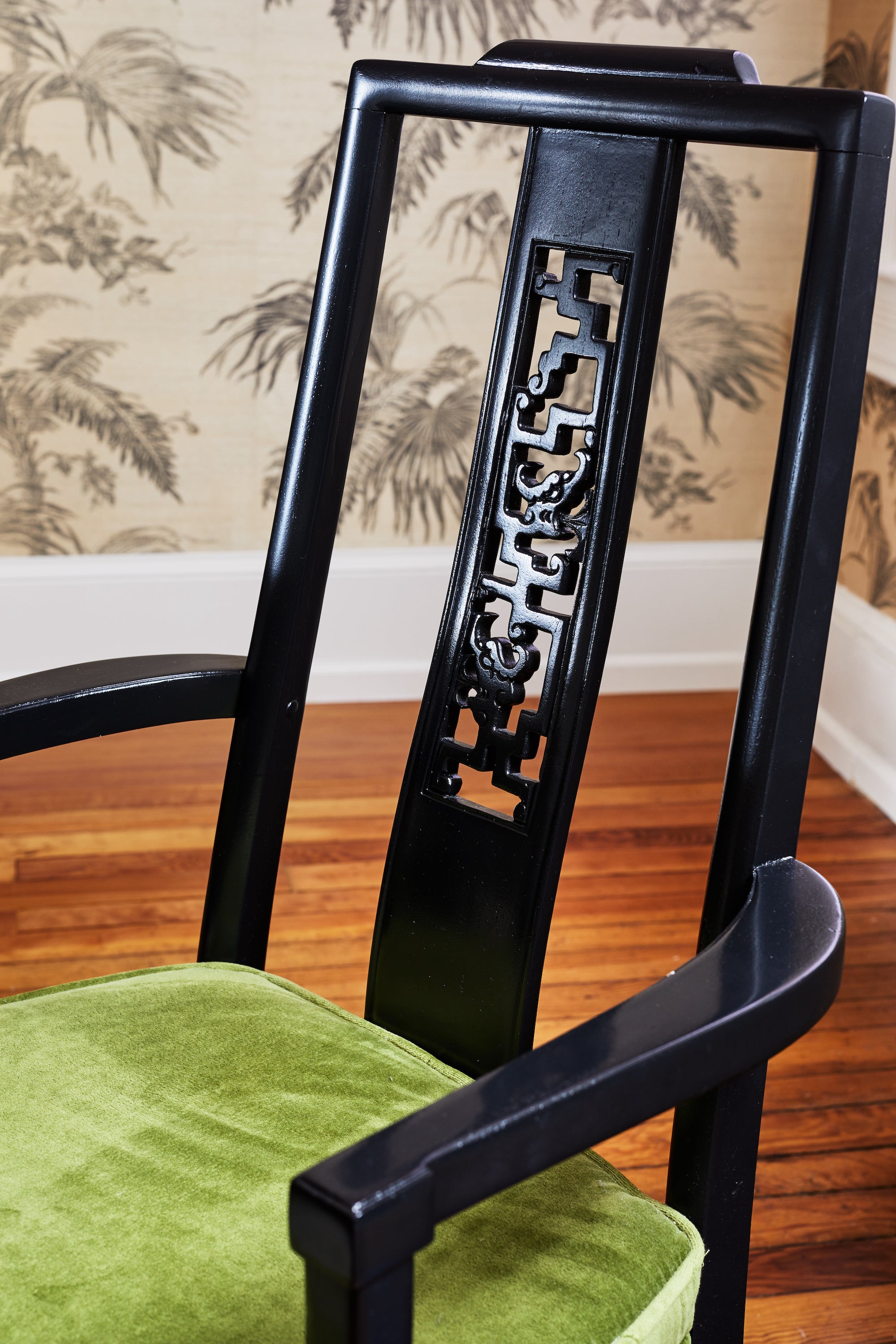 Black vintage dining chairs with green velvet upholstery by Lisa & Leroy.