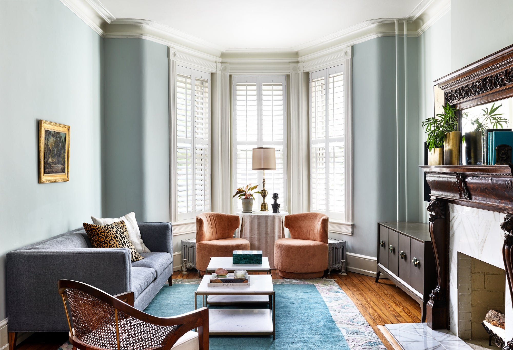 A timeless living area featuring an original fireplace and classic furnishings, by Lisa & Leroy.