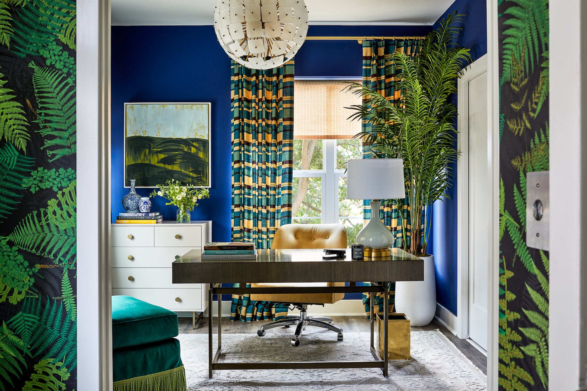 A home office of bold blues and greens in saturated patterns, by Lisa & Leroy.