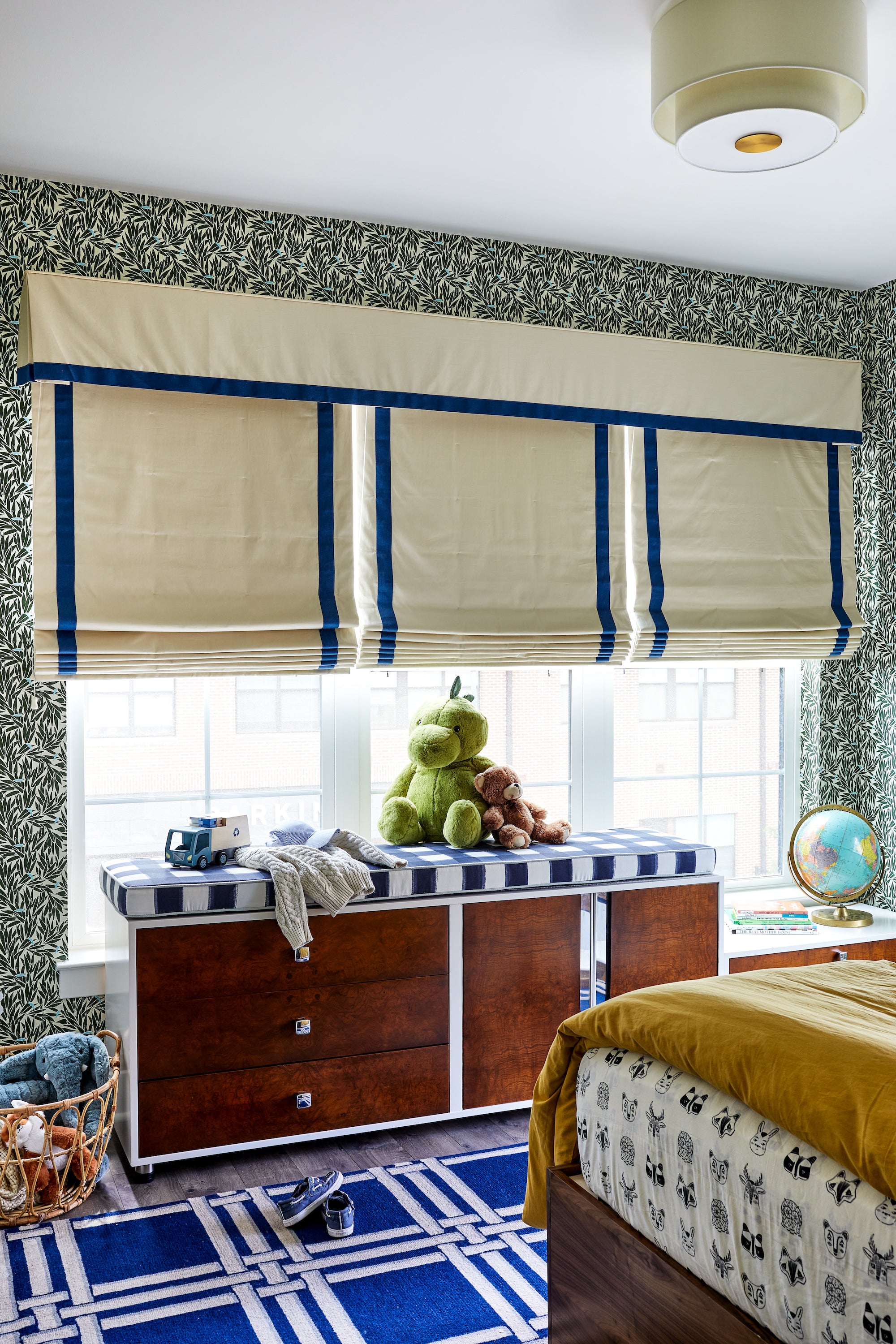 A wallpapered bedroom featuring patterns of blue and white and colorful layers, by Lisa & Leroy.