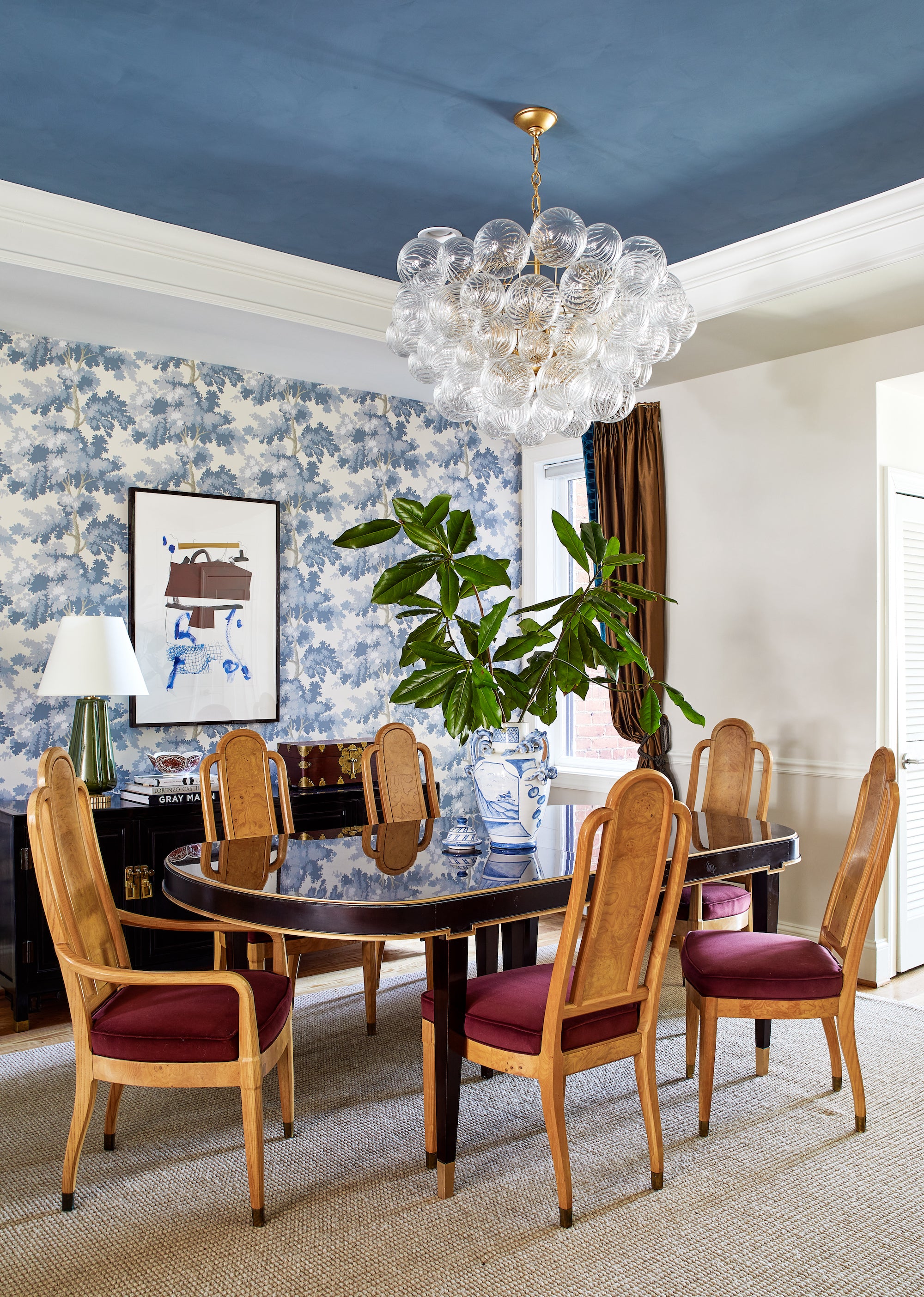 Classic meets eclectic in this dining area by Lisa & Leroy, with elements of rich blue and burgundy.