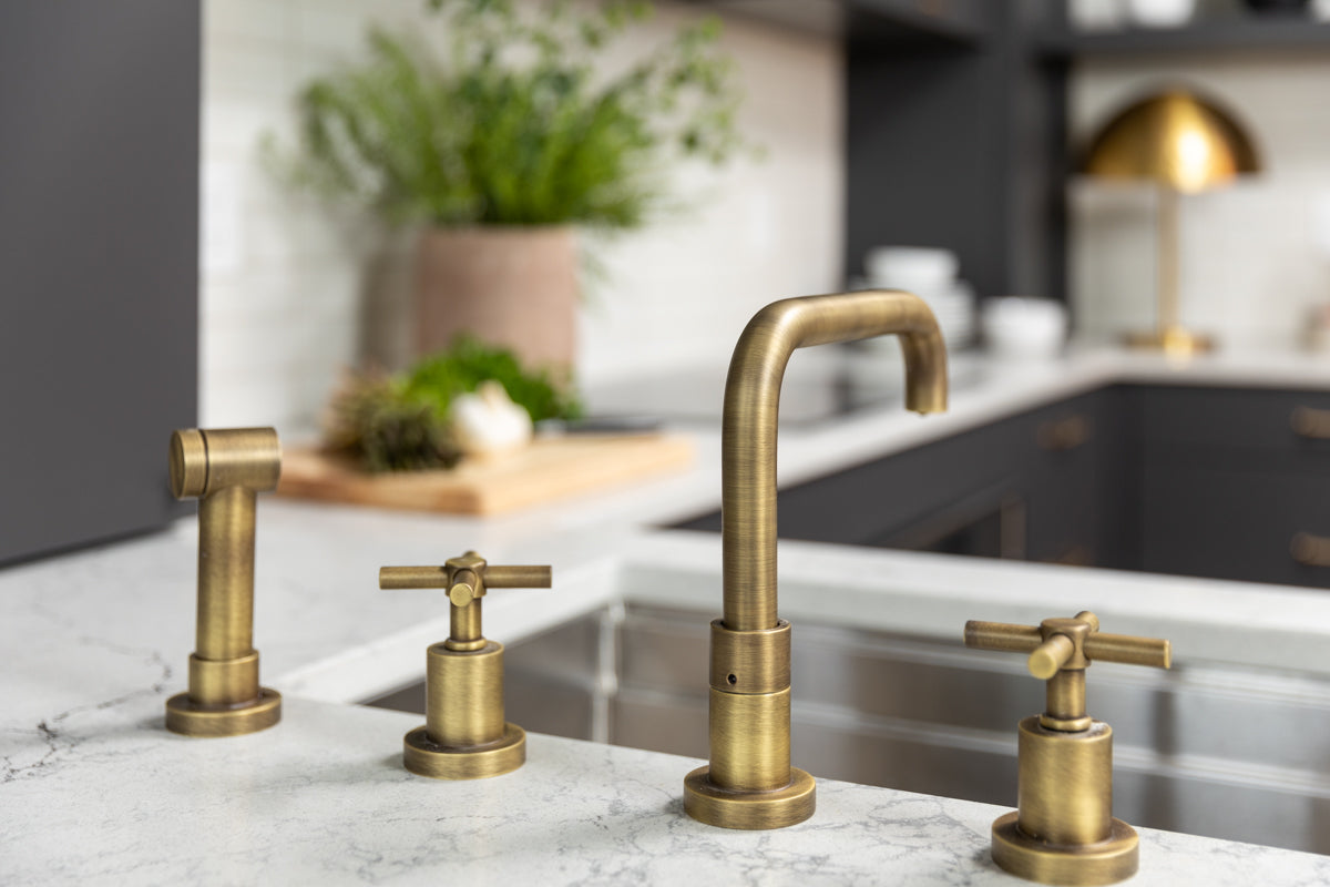 Brass fixtures in a modern kitchen designed by Lisa & Leroy.