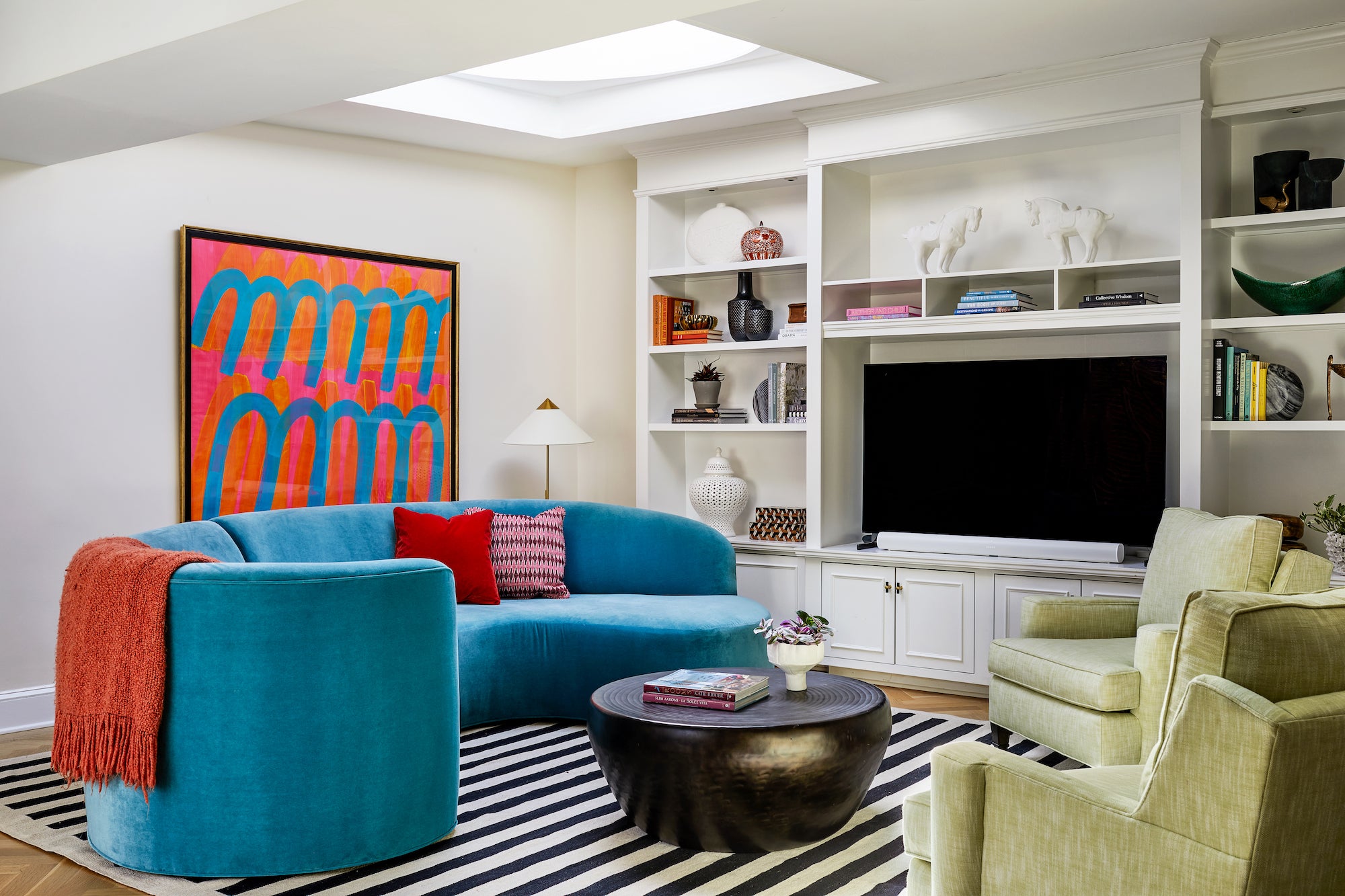 A modern living area with a statement blue sofa by Lisa & Leroy.
