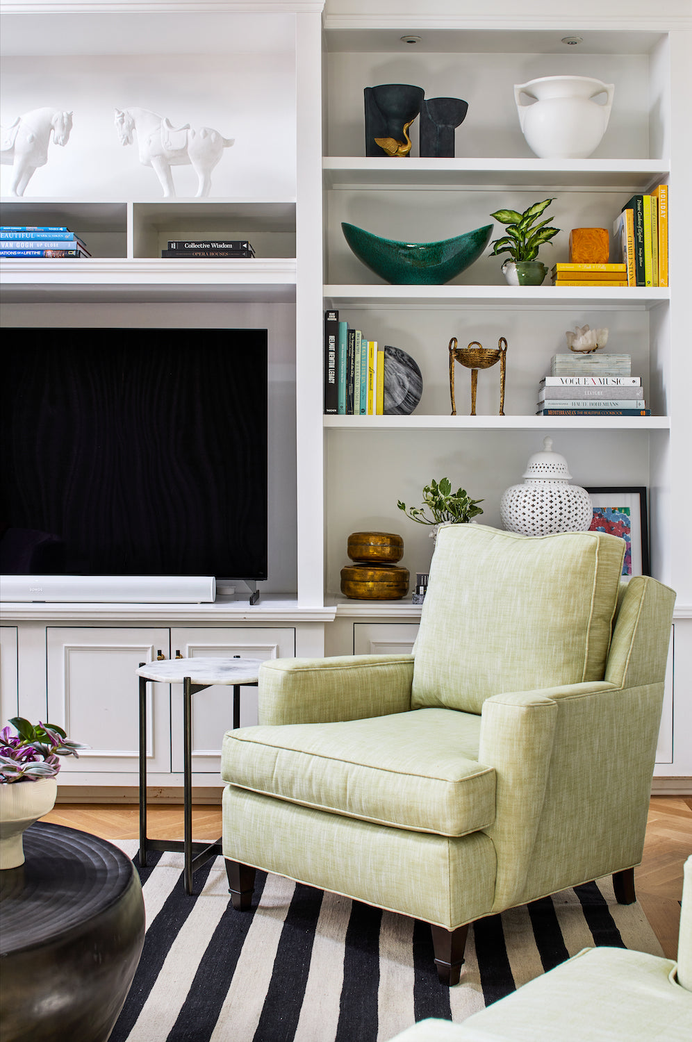 A modern living area with a statement green chair by Lisa & Leroy.