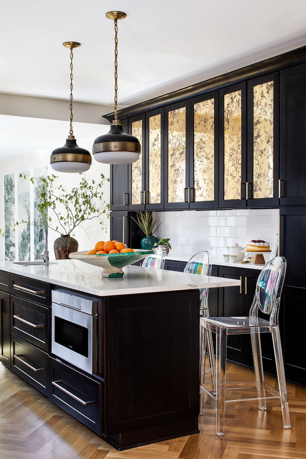 Custom black cabinetry with brass accents by Lisa & Leroy.