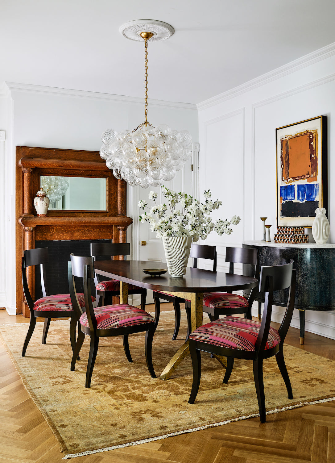 A mix of old and new furnishings in an eclectic dining room by Lisa & Leroy.
