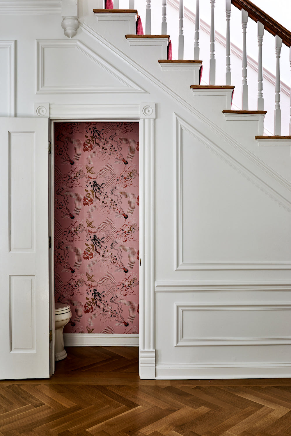 A view into a wallpapered powder room by Lisa & Leroy.