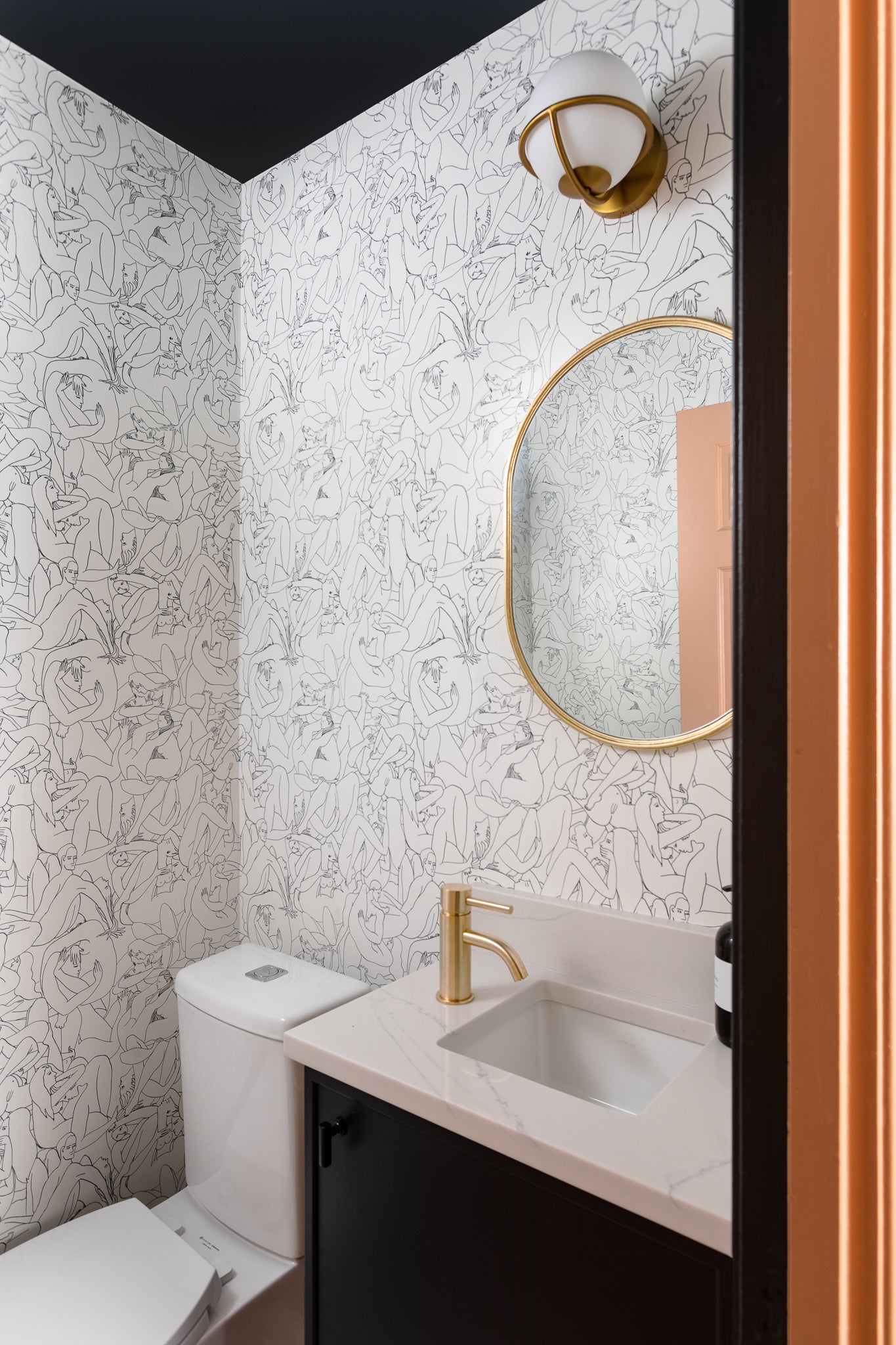 An airy powder bath with patterned wallpaper by Lisa & Leroy.